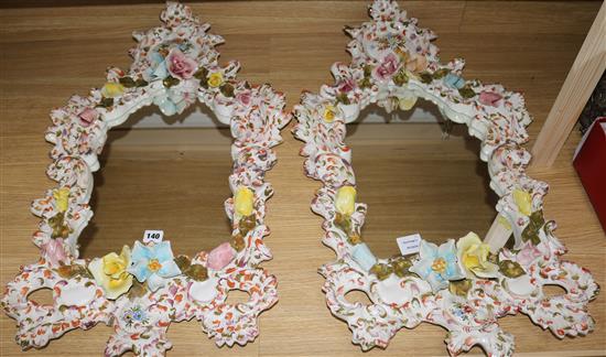 A pair of floral ceramic mirrors